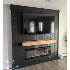 a flat screen tv mounted to the side of a wall above a fire place in a living room