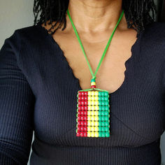 Rasta Flag Car Danglers/ Necklace . Mini Beaded Flag 2.5" x 3". Adjustable. Rectangular Beaded Necklace With Large Beads For Gifts, Green Beaded Rectangular Necklace, Green Rectangular Beaded Necklace, Adjustable Multicolor Rectangular Beaded Necklaces, Multicolor Beaded Rectangular Necklace, Adjustable Beaded Necklace With Large Pendant, Adjustable Pendant Beaded Necklace With Large Beads, Adjustable Multicolor Necklace With Large Pendant, Adjustable Large Pendant Multicolor Necklace