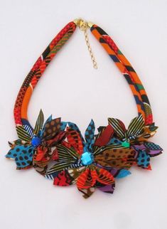 This could be an original and unique idea to give this necklace as gifts to the bridesmaid, bride etc. especially if you are organizing an unusual wedding with your personalized African touch, Boho wedding or your choice of wedding theme. It is a stunning flower necklace that I made with African wax print fabric.length of the necklace is 19 inches or 48 cm.Care: This is a fabric necklace so minimum care should be taken e.g.Do not sleep, bathe or exercise while wearing this necklace. In case of s Multicolor Handmade Flower Jewelry For Wedding, Multicolor Handmade Flowers Wedding Jewelry, Handmade Multicolor Flower Wedding Jewelry, Unique Handmade Flower Jewelry For Wedding, Unique Handmade Flower Jewelry For Gifts, Unique Handmade Flower Jewelry As Gift, Multicolor Flower Jewelry For Wedding, Multicolor Flower-shaped Wedding Jewelry, Multicolor Unique Design Necklace As Gift