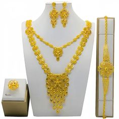 Indulge in luxury with this exquisite Dubai Gold Necklace Set, perfect for wedding parties. With its opulent design and superior craftsmanship, this set features a necklace, bracelet, earrings, and ring. Make a lasting impression and elevate your style with this luxurious jewelry set.' Elegant Alloy Jewelry As Gift, Plated Alloy Jewelry Sets For Wedding, Elegant Alloy Jewelry Sets For Gifts, Elegant Alloy Bridal Necklace As Gift, Elegant Alloy Bridal Necklace For Gift, Elegant Alloy Bridal Necklace Gift, Elegant Gold Plated Jewelry For Party, Wedding Alloy Plated Jewelry Sets, Wedding Jewelry Sets In Plated Alloy