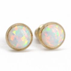 These opal stud earrings are beautiful. They feature a single 6mm simulated opal cabochons. Hand bezel set in my studio. 6mm Simulated Opal Round Cabochons Solid 925 Sterling Silver or 14/20 Gold Filled Deluxe Luxlock Backs-Safe, Secure, Comfortable Artisan Made in Texas Arrives thoughtfully packaged in a signature jewelry box Check out all of my opal earrings: https://www.etsy.com/shop/KMBankston/search?search_query=opal+earring&order=date_desc&view_type=gallery&ref=shop_search ~ Ab Classic Opal Cabochon Jewelry, Hypoallergenic Round Opal Jewelry, Minimalist Ethiopian Opal Round Jewelry, Yellow Gold Opal Jewelry In Round Shape, Yellow Gold Round Opal Jewelry, Classic Opal Jewelry As A Gift, Classic Opal Jewelry For Gifts, Dainty Round Ethiopian Opal Jewelry, Round Ethiopian Opal Jewelry For Gift