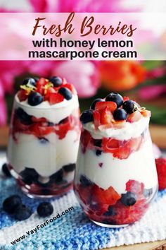 fresh berries with honey lemon mascarpone cream in small glass dishes on a blue towel