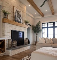 a living room with a couch, fireplace and tv in it's centerpiece