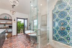 a large bathroom with a glass shower door