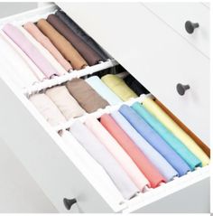 an open drawer filled with lots of different colored sheets