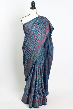 Add a touch of timeless elegance to your wardrobe with our Hand Printed Ajrakh Saree on Modal Silk in Blue. This stunning saree features intricate traditional Ajrakh printing and is crafted from luxurious modal silk fabric, making it a statement piece for any special occasion. The beautiful blue hue adds a pop of color to your ensemble, while the soft and smooth texture of the modal silk ensures utmost comfort. Each saree is meticulously hand printed by skilled artisans, making it a truly unique Blue Kalamkari Pre-draped Saree For Diwali, Indigo Traditional Drape For Navratri, Blue Chanderi Pre-draped Saree With Motifs, Bohemian Style Pre-draped Saree In Slub Silk, Traditional Block Print Cotton Silk Pre-draped Saree, Bohemian Style Pre-draped Slub Silk Saree, Blue Cotton Silk Saree With Kalamkari Print, Blue Cotton Silk Traditional Wear With Kalamkari Print, Bohemian Pre-draped Saree In Slub Silk For Diwali