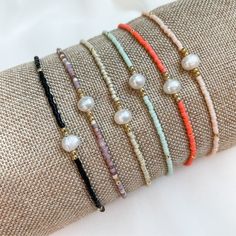 "Add a little Boho Chic to your everyday look with our latest pearl accent beaded bracelets.  Pair them with other bead bracelets, your favorite gold or silver bracelets, or even your watch for the stack of the season. Details:  Miyuki Glass Beads, Freshwater Pearl, Nylon Cord Bracelets expand from 6\" to 10\" A little bit about us: Mom-owned Business Sourcing only the highest quality materials Quick shipping from Colorado" Adjustable Beads With Pearl Charm, Elegant Tiny Beads Friendship Bracelets For Beach, Minimalist Pearl Bracelet With Tiny Round Beads, Dainty Pearl Beaded Bracelets With Round Beads, Beaded Bracelet With Pearl Charm As Gift, Adjustable Pearl Bracelet With Colorful Beads, Pearl Beaded Bracelets For Beach With Tiny Beads, Beach Pearl Beaded Bracelets With Tiny Beads, Gift Beaded Bracelet With Pearl Charm