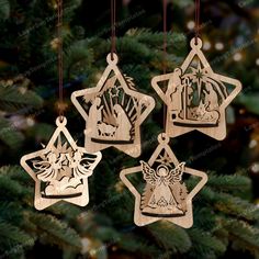 four wooden ornaments hanging from a christmas tree