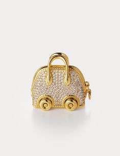 Inspired by Hermes Bolide On Wheels Bag Charm, Aelysee has meticulously crafted the Mini Bolide On Wheels Bag Charm, incorporating unique design elements. The charm features a separate clasp and chain, allowing you to customize it effortlessly with any of your handbags. Electroplated brass with round brilliant Zircon Charm size - 30 x 18.3 x 28.8mm Total weight 38g One year warranty Gold Travel Bag With Lock, Luxury Small Travel Bags, Small Elegant Travel Bag, Luxury Gold Bag Charm As Gift, Elegant Rectangular Bag Charm, Elegant Gold Bag Charm For Gift, Elegant Gold Bag Charm As Gift, Small Luxury Bags, Mini Bolide