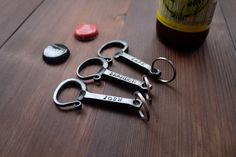 two bottle openers sitting on top of a wooden table