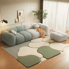 a living room with a couch, chair and rugs on the wooden flooring