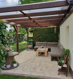 an outdoor living area with couches and tables