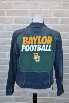 Baylor Football Repurposed Vintage Jean Jacket with a Hand-Stitched heart on the sleeve. Sic 'Em Bears! This jacket fits like a M-L. Step into the world of Repurposed Vintage Jean Jackets, Flannels, Military Jackets, & Military Flight Suits where fashion meets sustainable innovation! These carefully curated pieces have been meticulously sourced and transformed, breathing new life into forgotten fabrics. - These one-of-a-kind creations are not replicated; instead, they are reinvented into a uniqu Fall Denim Jacket For College, College Denim Jacket For Fall, Fall Long Sleeve Outerwear With Collage Stitching, Fitted Outerwear With Embroidered Patch For Fall, Fitted Fall Outerwear With Embroidered Patch, Fitted Long Sleeve Outerwear With Patches, Painting Denim, Baylor Football, Flight Suits