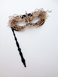 "Masquerade mask on a stick decorated with Gold lace overlay & Topaz/Crystal Rhinestones (more color available). The Mask comes attached to the stick. Perfect for any masquerade ball or costume party. Thank you for supporting small businesses and hope our products bring you and loved ones some joy and humor in these trying times. S H I P P I N G - Current processing times range 5-7 days. Pls note expedited & 1-2 day guaranteed delivery services offered will still require the same process Luxury Black Elegant Masks, Black And Gold Masquerade Mask Stick, Elegant Adjustable Masquerade Mask For Mardi Gras, Elegant Masquerade Mask For Festivals, Elegant Wedding Masquerade Mask Adjustable, Elegant Adjustable Masquerade Mask, Elegant Adjustable Masquerade Mask For Wedding, Elegant Adjustable Wedding Masquerade Mask, Elegant Party Masks And Prosthetics