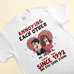 The "Annoying Each Other, Still Going Strong" Personalized Unisex T-Shirt is the perfect gift for couples who know how to embrace the fun side of their relationship. Whether it's for an anniversary, engagement, wedding, or just to celebrate your strong bond, this customizable couple shirt is a great choice. The humorous and personalized design adds a special touch, showcasing your unique connection. It's a fun way to acknowledge the ups and downs of your journey together while reaffirming your e Anniversary Tops With Funny Text And Short Sleeves, Anniversary Crew Neck T-shirt With Custom Print, Funny Text Crew Neck Top For Anniversary, Funny Text Crew Neck T-shirt For Anniversary, Anniversary T-shirt With Funny Text, Crew Neck, Funny T-shirt With Custom Text For Gift, Custom Text Crew Neck Top For Anniversary, Couples Style Tops For Valentine's Day Gift, Funny Text Tops For Valentine's Day Gift