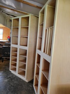 an empty room with wooden shelves in it