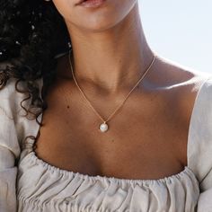 Introducing the Anna Pendant - a stunning, handmade piece of jewelry crafted with gorgeous Mother of Pearl and finished with a delicate gold rolo chain. This unique pendant is sure to be your favorite go-to accessory, adding just the right amount of glimmer and style to any outfit. Don't you deserve to feel luxurious and beautiful? Available in 14k gold plated brass 10mm Mother of Pearl Cabochon 18" rolo chain with 2" extender Lobster claw closure SKU: BYN1375 Elegant Everyday Charm Necklace With Cable Chain, Classic Necklace With Adjustable Chain As Gift For Her, Gold Pearl Necklace For Everyday, Dainty Gold-plated Charm Necklace With Pearl Pendant, Elegant Rose Gold Charm Necklace In Recycled Gold, Round Pendant Cable Chain Jewelry As Gift, Dainty Gold Plated Necklace With Pearl Pendant, Dainty Gold-plated Necklace With Pearl Pendant, Timeless Gold Pearl Necklace As A Gift