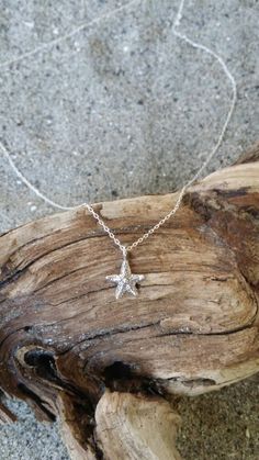 "Tiny sterling silver starfish pendant. The sterling silver charm is a dainty 9mm with a shiny finish. It has a delicate sterling silver chain and clasp. Shown here in 17\" length. *If you are unsure of the length you need, or would like to wear this item at different lengths, we now offer an adjustable length option! You can add an adjustable end to your necklace using this link: https://www.etsy.com/listing/791277751/necklace-extension-added-to-your All items are gift wrapped and shipped witho Sterling Silver Starfish Necklace As Gift, Sterling Silver Starfish Charm Pendant Necklace, Sterling Silver Starfish Charm Necklace, Sterling Silver Pendant Necklace With Starfish Charm, Sterling Silver Starfish Necklace With Star Charm, Ocean-inspired Sterling Silver Charm Necklaces, Ocean-inspired Silver Sterling Charm Necklaces, Sterling Silver Ocean-inspired Jewelry With Star Charm, Sterling Silver Starfish Charm Jewelry