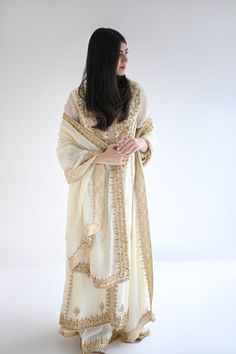 This beautiful classic three piece is designed on pure handloom pastel yellow cotton net embellished with intricate detailed gold hand/ada work in dabka, sequins, naqshi and crystals. Styled with a matching heavy dupatta and ivory culottes for a head turning style statement. Order Duration: 4 to 6 weeks Gold Boutique, Heavy Dupatta, Boutique Suits, Gold Hand, Suit Designs, Gold Hands, Pastel Yellow, Style Statement, Three Piece