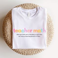 a white t - shirt with the words teacher math printed on it next to a wicker basket