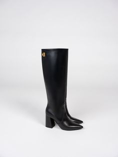 For this season, we've introduced several firsts, and this pair of boots is one of them. ROGUE, crafted from smooth calf skin leather with Italian refined craftsmanship, features sleek pointed toes and chunky heels, ensuring comfort at any event this holiday. We've also adorned them with our new emblem, adding a touch of elegance to every step. Luxury Knee-high Boots With Sculpted Heel And Square Toe, Luxury Knee-high Boots With Square Toe And Reinforced Heel, Luxury Knee-high Boots With Reinforced Heel And Square Toe, Elegant Platform Boots With Pointed Toe For Business, Elegant Platform Boots With Stacked Heel In Calf Leather, Luxury Platform Boots With Sculpted Heel And Pointed Toe, Luxury Knee-high Platform Boots For Formal Occasions, Luxury Knee-high Platform Boots For Work, Luxury Heeled Boots With Sculpted Heel And Snip Toe