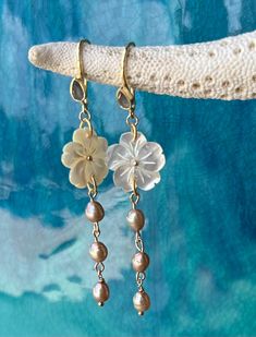 Beautiful carved mother of pearl flower on gold vermeil earrings with a labradorite tear drop gemstone and champagne fresh water pearls.  High quality gold vermeil earrings.  The earrings measure approximately 2 3/4" long.  Flower is approximately 1".  Freshwater pearl dangle measures 1.5". Simple and elegant chic look! Beautiful bridesmaid gift, perfect for a beach wedding! Ships ready for gifting in wrapped in a gauze bag. Pierced Round Pearl Jewelry, Unique Mother Of Pearl Drop Jewelry, Yellow Gold Mother Of Pearl Jewelry With Pearl Drop, Unique Mother Of Pearl Jewelry For Wedding, Delicate Drop Earrings With Ear Wire, Unique Pearl Jewelry For Anniversary, Elegant Mother Of Pearl Flower Shaped Jewelry, Handmade Mother Of Pearl Jewelry For Anniversary, Dangle Jewelry With Pearl Charm For Anniversary