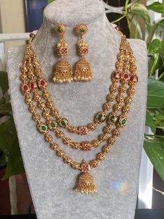 "24 K gold plated beaded long necklace with matching delicate earrings Three Layer Short Mala/ Indian Necklace/ Indian Long Necklace/ Long Gold Necklace/ Indian Jewelry/ Indian Necklace/ Punjabi Jewelry Highest quality and craftsmanship Indian Bridal Traditional One Gram Jewelry Necklace Set. Length : 16 \" All the raw material used in this product is of high quality and is handcrafted with love. Premium Quality and High craftsmanship 100% Satisfaction Guarantee: Long Lasting Plating, High-Quali 3 Layer Chain Necklace Gold Indian, Three Layer Necklace Gold Indian, Long Gold Earrings Indian Jewelry, 3 Layer Necklace Gold Indian, Gold Layer Necklace, Beautiful Gold Necklace Bridal Jewelry, Layer Chain Gold Indian, Gold Balls Chain Indian, Mala Set In Gold