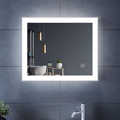 a bathroom sink with a mirror above it and a light on the wall behind it