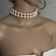 Add a touch of timeless elegance to your jewellery collection with this stunning White Shell Pearls Necklace with 2 layers of 12mm pearls and luxurious gold rhinestones. Each glossy bead is crafted to mimic the radiant beauty of real pearls, creating a sophisticated and versatile piece. They are luxurious, heavy and cold, just like the real ones. Materials: 12mm Shell Pearls, gold rhinestones, gold plated stainless steel clasp Shell pearls are made from crushed shells. Oyster shells are cut and transformed into powder and then reformed into perfect pearl shape with an infinite shine.  They are very popular as a natural alternative to expensive pearls.  Available lengths: - 12 inches/30.5cm  - 12.5 inches/31.7cm  - 13 inches/33cm  - 13.5 inches/34.3cm  - 14 inches/35.5cm  - 14.5 inches/36.8 Elegant Gold Pearl Choker, Elegant Bridal Choker Necklace, Elegant Double Strand Gold Pearl Necklace, Elegant Pearl White Choker With Round Beads, Elegant Gold Double Strand Pearl Necklace, Elegant Round Beads Choker For Formal Occasions, Elegant Round Beads Choker For Formal Events, Elegant Round Beads Formal Choker, Elegant Formal Choker With Round Beads