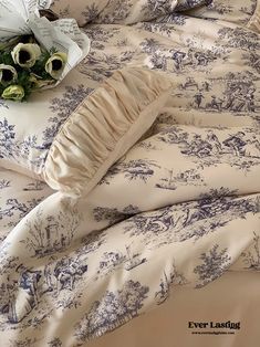 the comforter is made up with blue toiler designs and ruffled edges