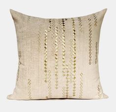 a white pillow with gold lines on it