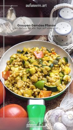 a white bowl filled with vegetables on top of a table next to other food items