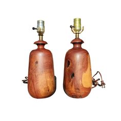 two wooden lamps with metal fittings on them