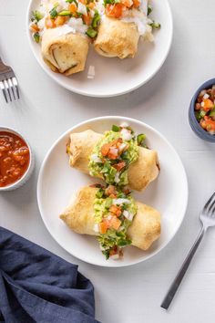 two white plates topped with food next to a bowl of salsa