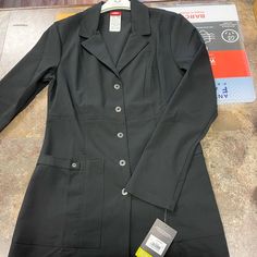 Button Up Lab Coat With Two Pockets And Two Pen Pockets Style: 82400 Black Flat Front Blazer For Work, Professional Button-up Outerwear For Office, Black Button-up Blazer With Pockets, Tailored Professional Black Outerwear, Black Blazer With Button Closure For Office, Black Button-up Outerwear For Work, Black Blazer With Button Closure For Work, Black Blazer For Work With Button Closure, Professional Black Long Sleeve Blazer