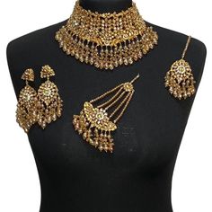 Asian jewellery set. Set includes- Necklace  Earrings  Jhumar  Tikka Ceremonial Gold Kundan Necklace With Stone Work, Ceremonial Gold Kundan Necklace Hand Set, Gold Jewelry With Stone Work For Celebration, Gold Bollywood Sets For Wedding, Bollywood Style Gold Wedding Sets, Heavy Kundan Jewelry Sets For Festive Occasions, Heavy Kundan Jewelry Sets For Festive Season, Gold Chandbali Jewelry Sets Hand Set, Heavy Gold Plated Jewelry Sets For Festivals