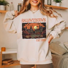 Halloweentown Est 1998 Tee/Sweatshirt Comes in 4 colors - White, Ash Grey, Tan and Black Tee: $32Sweatshirt: $48Unisex sizing Sizes: S-4XLTAT: 7-10 business days 90s Long Sleeve Sweatshirt For Fall, 90s Long Sleeve Fall Sweatshirt, 90s Style Long Sleeve Fall Sweatshirt, 90s Graphic Print Fall Sweatshirt, 90s Long Sleeve T-shirt For Fall, 90s Style Long Sleeve T-shirt For Fall, 90s Letter Print Sweatshirt For Fall, White 90s Sweatshirt For Fall, 90s Letter Print Fall Sweater