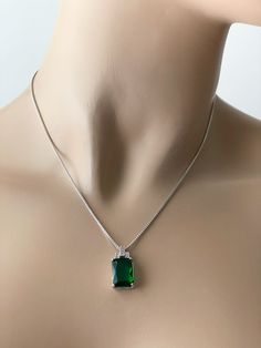 Emerald Sterling Silver Rectangular CZ Necklace. 925 Sterling Silver Stone: Green (Emerald) Pendant Height: 11 mm Pendant Width: 9 mm Emerald the Birthstone of May Epitomizes: Love, Loyalty & Faithfulness Includes a Sterling Silver Box Chain (16, 18, or 20 Inches). Sterling Silver Rectangular Jewelry For May Birthstone, Elegant May Birthstone Necklace With Rectangular Stone, Elegant Rectangular Jewelry With Stones, Elegant Rectangular Stone Jewelry, Formal Emerald Necklace With Rectangular Pendant, Silver Jewelry With Rectangular Emerald, Silver Emerald Jewelry With Square Cut, Elegant Green Oblong Jewelry, Silver Emerald Square Cut Jewelry