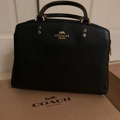 Adorable Medium Size Black Coach Purse. Never Used, With Tags Still On! It Comes With An Adjustable Shoulder Strap, Or Could Be Carried By The Handles. One Large Main Compartment With Zipper In The Middle And Storage On Both Sides (3 Separate Slots Total). Elegant Coach Satchel With Branded Hardware, Elegant Black Satchel With Branded Hardware, Elegant Coach Satchel For Formal Occasions, Elegant Coach Bags, Elegant Black Coach Satchel, Coach Black Formal Satchel, Black Coach Satchel For Formal Occasions, Formal Black Coach Satchel, Designer Coach Satchel