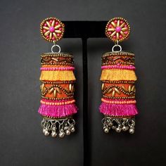 Fun and playful Afghani fringe earrings, with gold tone bead work. The perfect summer earring, colorful and carefree. Fabric backed ear stud ensures a comfortable fit. The main body is fabric wrapped around a metal cylinder. Beautiful vibrant colors. Little bells make a lovely sound when you move your head. Weight 21 gm. Find even more great earrings here: https://www.etsy.com/shop/boutiquebymaryam?section_id=22797814 Be sure to visit the rest of my shop here: https://www.etsy.com/shop/boutiqueb Ghungroo Jewellery, Bellydance Jewelry, Afghani Jewelry, Fabric Necklaces, Silk Thread Earrings, Metal Cylinder, Oxidised Silver Jewelry, Belly Dance Jewelry, Fabric Jewellery