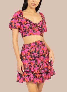 The Celia 2-Piece Candy Set will have you showing up with style and attitude. Influenced by style of numerous American immigrant cultures, this breezy matching fun printset featuring a cropped top with puff sleeves and a criss-crossed tie back, and a tired flare skirt to finish the sweet yet sassy style. Material: Polyester Hand Wash, Cool iron Sold as a set Fitted Two-piece Top For Spring, Summer Two-piece Crop Top Set, Fitted Flirty Short Sleeve Crop Top, Flirty Fitted Crop Top With Short Sleeves, Trendy Fitted Two-piece Crop Top Set, Trendy Fitted Two-piece Crop Top, Spring Party Crop Top With Puff Sleeves, Fitted Cropped Dress For Day Out, Flirty Short Sleeve Crop Top For Summer