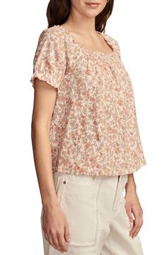 A cascading pattern of earthy flowers enlivens this all-cotton peasant top cut in a lightweight, flowy silhouette with smocked detail at the front and back. Square neck Short sleeves 100% cotton Machine wash, tumble dry Imported Feminine Flowy Smocked Top With Floral Print, Bohemian Peasant Top With Smocked Bodice, Spring Floral Print Blouse For Gatherings, Floral Print Blouse For Spring Gatherings, Bohemian Short Sleeve Top With Smocked Back, Bohemian Tops With Smocked Back And Short Sleeves, Bohemian Summer Tops For Gatherings, Casual Spring Tops For Gatherings, Spring Smocked Top For Gatherings