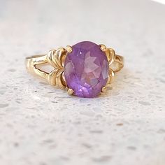 Beautiful solid yellow 9 ct gold vintage ring set with a large, subtle lilac, Amethyst gemstone. Fully UK hallmarked. INTERNATIONAL BUYERS - please read the shipping information below. Follow us on Instagram for all our latest pieces and first Dibs! They don't all make it to our Etsy store: https://www.instagram.com/mooreperfectpieces/ Hallmarked 9 ct gold. GTV Makers mark. Birmingham assay mark.  Size UK B 1/2 US 7 Eu 55 - suitable for resizing.  weight 3.54 g The face of the amethyst measures Timeless Purple 14k Gold Rings, Timeless 14k Gold Amethyst Ring For Anniversary, Classic Amethyst Ring Stamped 14k, Gold Solitaire Amethyst Ring For Formal Occasions, Heirloom Yellow Gold Solitaire Amethyst Ring, Heirloom Yellow Gold Amethyst Solitaire Ring, Heirloom Amethyst Solitaire Ring In Yellow Gold, Classic 14k Gold Purple Amethyst Ring, Timeless Gold Amethyst Ring