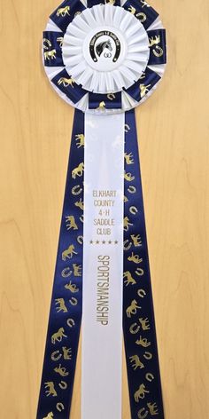 an award ribbon with gold horses on it