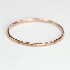 a close up of a gold ring on a white surface