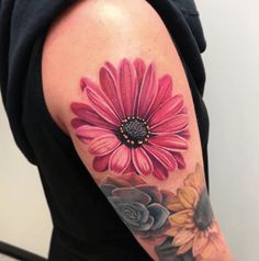 a woman with a flower tattoo on her arm