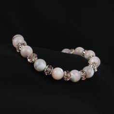 You'll love the soft pink colors in our pink mother of pearl bracelet. We've combined pink crystals and sterling silver accent beads for a delicate look. A beautiful gift for women of all ages! ABOUT: * Materials: sterling sliver lobster claw and sterling silver 1.5 inch extension * Beads: mother of pearl, glass beads, sterling bead caps * Width: 8mm SHOP OUR BRAND > https://rosaperlina.etsy.com WHAT IS STERLING SILVER? * Sterling silver is a mix of 92.5% of silver and 7.5% of other metals, typically copper. * The added copper gives sterling silver a great durability and strength. * Benefits are durability, higher percentage of real silver and better for sensitive skin. HOW TO CARE FOR STERLING SILVER? * Keep in an airtight container, away from moisture, heat, and sun in storage * Keep awa Pink Faceted Rondelle Beaded Bracelets, Elegant Pink Hypoallergenic Beaded Bracelets, Elegant Adjustable Pink Bracelet, Elegant Pink Opal Jewelry Gift, Elegant Pink Opal Jewelry For Gift, Elegant Pink Hypoallergenic Bracelet, Adjustable Pink Pearl Bracelet Feminine Style, Pink Adjustable Feminine Pearl Bracelet, Adjustable Feminine Pink Pearl Bracelet