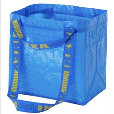 a blue shopping bag with yellow letters on the front and bottom, sitting against a white background