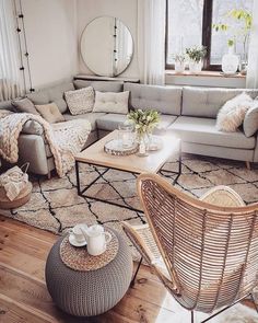 a living room filled with lots of furniture and decor on top of a hard wood floor