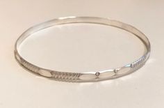 This is a cute bracelet. This sterling silver bangle is made with medium gauge sterling silver and it is about 1/4 inche wide. The bangles shown is 2.5 inches in diameter and will fit most wrists. it is also available 2.25, 2.75 and 3 inches in diameter. It looks great alone of stacked with other bracelets like this one: https://www.etsy.com/listing/569857013 How to measure your hand for a bangle: Make your hand as small as possible, as if you were putting on bangles, bringing your thumb and lit Cute Bracelet, The Bangles, Silver Bangle Bracelet, Bangles Making, Sterling Silver Bangle Bracelets, Grand Junction, Sterling Silver Bangle, Bracelet Sterling Silver, Silver Bangle Bracelets